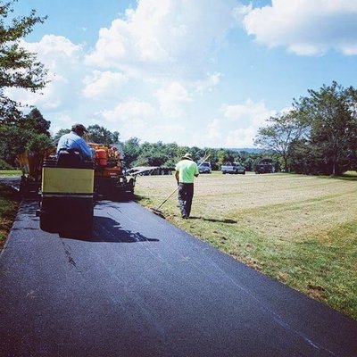 Asphalt Driveway Installation - In this project we changed a gravel driveway that spread dust everywhere to a paved asphalt driveway. Our customer was relieved to have less wear and tear on his vehicle now that he had a smooth driveway. His kids were thrilled to have a place to ride their bikes!