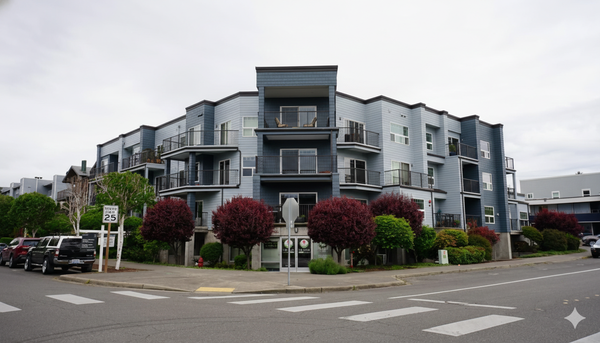 Multi family Exterior Painting Project - A contemporary mixed-use condo building anchors a quiet urban street corner, featuring clean lines, layered balconies, and a modern coastal color palette of cool blues and soft grays. The three-story structure emphasizes symmetry and depth, with recessed balconies and dark metal railings adding contrast and texture. Mature landscaping—burgundy and green foliage—frames the ground level, softening the architecture and enhancing curb appeal. Captured under an overcast sky, the image highlights the building’s calm, residential character while conveying a sense of livability and thoughtful urban design. Multi family Exterior Painting Project - A contemporary mixed-use condo building anchors a quiet urban street corner, featuring clean lines, layered balconies, and a modern coastal color palette of cool blues and soft grays. The three-story structure emphasizes symmetry and depth, with recessed balconies and dark metal railings adding contrast and texture. Mature landscaping—burgundy and green foliage—frames the ground level, softening the architecture and enhancing curb appeal. Captured under an overcast sky, the image highlights the building’s calm, residential character while conveying a sense of livability and thoughtful urban design.