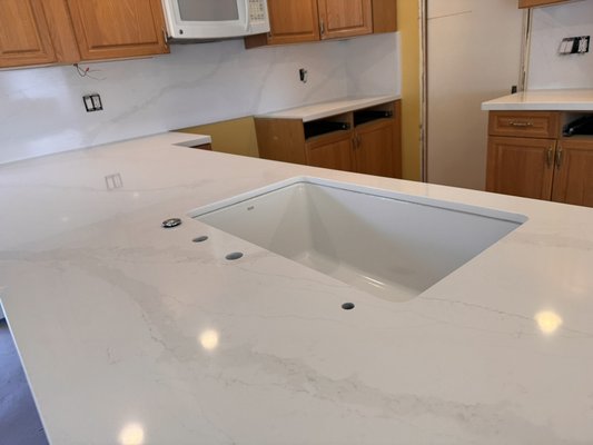 Varara Quartz kitchen countertop install in Montecito California. - This kitchen install was completed in six hours. From the moment we took our initial measurements, to pick up stone, to fabricate, and to come to our job site and a demo along with the install, the process took about five days. A white Verdera cord stone was installed, leading out to a luxurious finish!