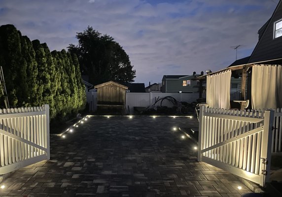 Pavers Lighting Installation - This client redid her driveway with pavers and wanted to add lighting to make it look esthetically pleasing and we recommended flushed fixtures embedded into the pavers. The end result was a beautifully lit driveway and a happy client.