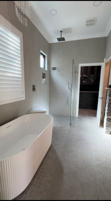 Completed luxury bathroom remodel - custom walk-in shower, freestanding tub, heated floors, floating vanity with LED mirror, and premium porcelain tile. Every detail was crafted with precision to create a timeless, elegant, and functional space.