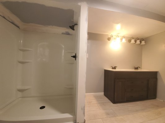 Bathroom Remodel - This remodel was in a house built in the 60's. We demoed and finished the full bathroom. We removed cast iron pipes and installed PVC and pex pipes. There was an old tile shower that was out dated and super small. Customer decided to go with full 60" shower surround! We installed drywall, floors, lights, shower, and vanity on this job. Bathroom Remodel - This remodel was in a house built in the 60's. We demoed and finished the full bathroom. We removed cast iron pipes and installed PVC and pex pipes. There was an old tile shower that was out dated and super small. Customer decided to go with full 60" shower surround! We installed drywall, floors, lights, shower, and vanity on this job.