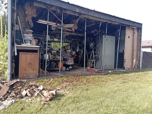 garage wall - The owner's garage wall was rotting and falling apart. We came in and tore the wall down and refrained it and put up a new wall. garage wall - The owner's garage wall was rotting and falling apart. We came in and tore the wall down and refrained it and put up a new wall.