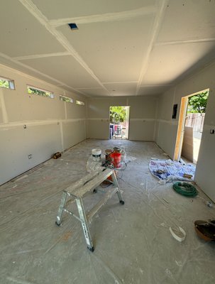 Drywall Installation - This Shed is a 24 feet by 14 feet with a 8 foot ceiling height. We installed R-30 insulation on the ceiling and R-13 Insulation on the walls. Then we applied 5/8's inch thick gypsum board. Next step was getting the corner bead on the windows and the tape coat. On the following day we applied two coats of compound mud and standard texture finish. Drywall Installation - This Shed is a 24 feet by 14 feet with a 8 foot ceiling height. We installed R-30 insulation on the ceiling and R-13 Insulation on the walls. Then we applied 5/8's inch thick gypsum board. Next step was getting the corner bead on the windows and the tape coat. On the following day we applied two coats of compound mud and standard texture finish.