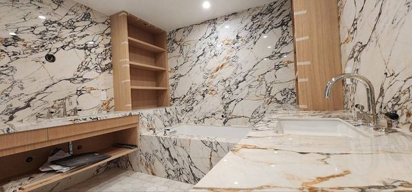 Bathroom, Shower Walls + | Porcelain Project - High-end project with porcelain slabs, see to believe it! The material used for the entire bathroom project is Porcelain Corchia Gold Lux. Our team does a top job installing all the porcelain walls and vanities. The project speaks for itself. That is our quality. Suppose you expect to start with a new project. In that case, we can help you in all aspects, beginning with the estimate and best deals with any material available in our showroom, and we offer you a full-year guarantee on the project, give us a call, and we can help you.