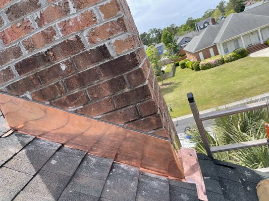 Copper Chimney Flashing - This is an example of the type of chimney flashing we install. Always keep in mind there’s a handful of flashing colors that can be installed based on your chimney, roof, or house color. Copper Chimney Flashing - This is an example of the type of chimney flashing we install. Always keep in mind there’s a handful of flashing colors that can be installed based on your chimney, roof, or house color.