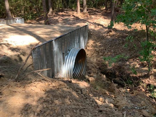 Creek Bridge - We assisted on this project to build a creek crossing for a customer. We hauled in the pipe, cleared the proposed driveway, installed the crossing with retaining walls. Creek Bridge - We assisted on this project to build a creek crossing for a customer. We hauled in the pipe, cleared the proposed driveway, installed the crossing with retaining walls.