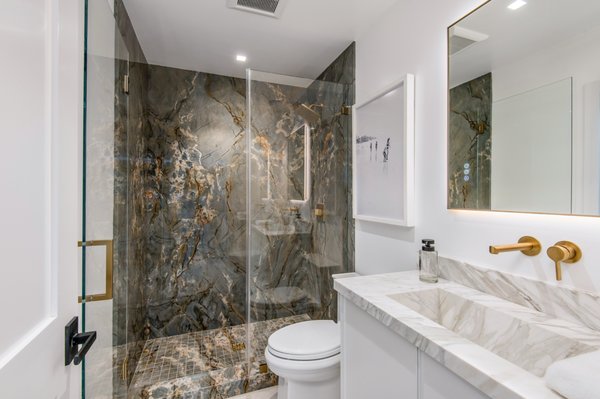Laguna Beach Shower Service 2024 - Experience modern luxury with this beautifully designed shower, featuring sleek porcelain slabs and elegant marble elements. The shower walls are clad in high-quality porcelain slabs, offering a clean and contemporary look with a durable finish. The same porcelain material is seamlessly used for the shower pan, creating a unified and sophisticated appearance. Complementing this modern design, the vanity is crafted from marble, providing a refined touch. The sink, also made from marble, perfectly matches the vanity, enhancing the overall cohesion and elegance of the space. This meticulously designed shower not only delivers a high-end aesthetic but also combines functionality with exceptional craftsmanship.
Elevate your bathroom with this modern masterpiece. Contact us today to explore how we can create a stunning shower experience tailored to your needs. Laguna Beach Shower Service 2024 - Experience modern luxury with this beautifully designed shower, featuring sleek porcelain slabs and elegant marble elements. The shower walls are clad in high-quality porcelain slabs, offering a clean and contemporary look with a durable finish. The same porcelain material is seamlessly used for the shower pan, creating a unified and sophisticated appearance. Complementing this modern design, the vanity is crafted from marble, providing a refined touch. The sink, also made from marble, perfectly matches the vanity, enhancing the overall cohesion and elegance of the space. This meticulously designed shower not only delivers a high-end aesthetic but also combines functionality with exceptional craftsmanship.
Elevate your bathroom with this modern masterpiece. Contact us today to explore how we can create a stunning shower experience tailored to your needs.