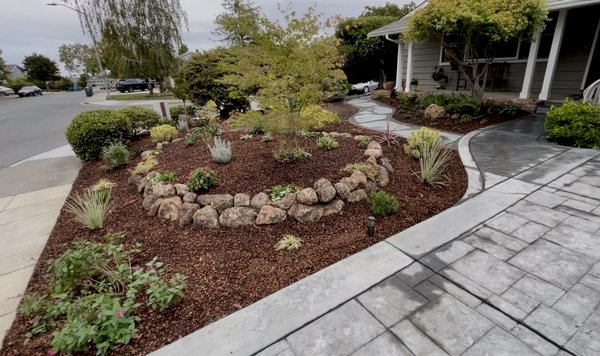 Landscape Renovation - Transform your outdoor space with a stunning landscape renovation, showcasing a effortlessly low-maintenance yard. Elevate the aesthetics with a raised area adorned with carefully selected plants, shrubs, and trees, all connected by an elegant flagstone walkway. Landscape Renovation - Transform your outdoor space with a stunning landscape renovation, showcasing a effortlessly low-maintenance yard. Elevate the aesthetics with a raised area adorned with carefully selected plants, shrubs, and trees, all connected by an elegant flagstone walkway.