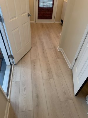 Project #203 - This LVP flooring project included installation throughout multiple areas of the home, creating a bright, clean, and cohesive look from room to room. The light wood-tone planks helped open up the spaces while adding a modern and elegant finish. The project also included matching stair work with white risers, giving the staircase a polished and seamless appearance. Overall, this installation delivered a durable, low-maintenance flooring solution with a fresh style that complements the home beautifully.