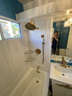 Bathroom Shower Remodel with Modern Panels and Dual Shower System in Los Angeles - Revamped an outdated bathroom by removing old tile around the tub and upgrading to contemporary waterproof panels, transforming it into a sleek, functional space. Started with careful demolition of the existing tile and fixtures, minimizing damage to walls and floors while protecting the area.
Installed moisture-resistant cement board as a base, applied Redguard waterproofing membrane for long-term protection against leaks, ensuring a dry, durable foundation. Repiped the plumbing with soldered connections to support a new dual shower system: an overhead rain shower for relaxing rinses and a handheld wand for flexibility.
Tiled the lower row with ceramic for a classic touch, then fitted upper panels with precise cuts around the window for seamless integration and unified style. Patched, spackled, and painted walls for a fresh finish.
Tested the system for perfect flow—no drips or issues. Completed in 4 days with minimal disruption, this upgrade adds luxury and prevents mold. Ideal for busy LA homes seeking easy maintenance and spa-like comfort.
Ready for your bathroom refresh? Contact me for a free estimate—let’s create your dream space! Bathroom Shower Remodel with Modern Panels and Dual Shower System in Los Angeles - Revamped an outdated bathroom by removing old tile around the tub and upgrading to contemporary waterproof panels, transforming it into a sleek, functional space. Started with careful demolition of the existing tile and fixtures, minimizing damage to walls and floors while protecting the area.
Installed moisture-resistant cement board as a base, applied Redguard waterproofing membrane for long-term protection against leaks, ensuring a dry, durable foundation. Repiped the plumbing with soldered connections to support a new dual shower system: an overhead rain shower for relaxing rinses and a handheld wand for flexibility.
Tiled the lower row with ceramic for a classic touch, then fitted upper panels with precise cuts around the window for seamless integration and unified style. Patched, spackled, and painted walls for a fresh finish.
Tested the system for perfect flow—no drips or issues. Completed in 4 days with minimal disruption, this upgrade adds luxury and prevents mold. Ideal for busy LA homes seeking easy maintenance and spa-like comfort.
Ready for your bathroom refresh? Contact me for a free estimate—let’s create your dream space!