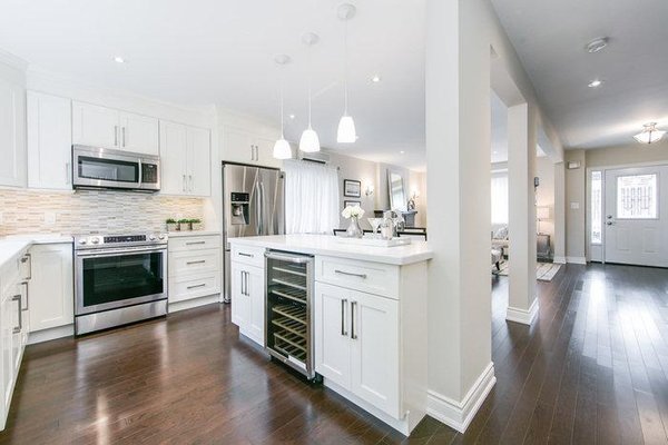 Condo unit remodeled - This remodel was done using DELONG laminate 7*1/3" with 2mm underpad. The new floor installation in whole area including kitchen, dining area, living room and 3 bedrooms, the new kitchen cabinet and countertop with paint gave it a fresh, gorgeous look.
