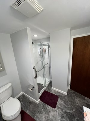 Bathroom renovation - Full bathroom renovation. Expanded bathroom into hollow space next to shower. Installed larger new shower, shower doors, vanity, sink, flooring, added recessed lighting, and installed new light fixtures, mirrors, and medicine cabinet Bathroom renovation - Full bathroom renovation. Expanded bathroom into hollow space next to shower. Installed larger new shower, shower doors, vanity, sink, flooring, added recessed lighting, and installed new light fixtures, mirrors, and medicine cabinet