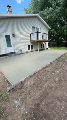 Weston Concrete Pad - This is a concrete pad poured for a family in Weston. Get your yard elevated today for your next cookout. 
 
The second photo is a garage door exit concrete pad. The lady plans on using it for her trash bin or hose bin storage.