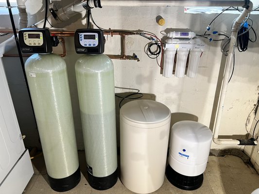 Water Filtration Solutions - Benefits of a Home Water Softener
A water softener removes hardness-causing minerals (mainly calcium and magnesium) through an ion exchange process. Benefits include:
1. Extended Appliance Lifespan
Reduces scale buildup in water heaters, dishwashers, and washing machines, helping them last longer.
2. Improved Efficiency
Soft water heats more efficiently, reducing energy consumption and utility bills.
3. Cleaner Plumbing System
Prevents mineral buildup in pipes, reducing the risk of clogs and corrosion.
4. Better Soap & Detergent Performance
Soft water allows soap to lather more easily, improving cleaning and reducing the amount needed.
5. Softer Skin and Hair
Eliminates the drying effect of hard water, leaving skin and hair feeling softer and smoother.
6. Spot-Free Dishes & Glassware
Minimizes white spots and streaks on dishes and fixtures.
Benefits of Reverse Osmosis (RO) for Drinking Water
A reverse osmosis system uses a semi-permeable membrane to remove impurities from water at the molecular level. Benefits include:
1. Exceptional Purity
Removes up to 99% of contaminants including lead, arsenic, fluoride, nitrates, chlorine, and PFAS.
2. Improved Taste and Odor
Eliminates unpleasant tastes and smells caused by chlorine and dissolved solids.
3. Healthier Drinking Water
Reduces exposure to harmful contaminants that can affect long-term health.
4. Cost Savings
Cuts down on bottled water purchases, reducing plastic waste and expenses.
5. Convenience
Provides clean, filtered water right from the tap for drinking, cooking, and even pet use. Water Filtration Solutions - Benefits of a Home Water Softener
A water softener removes hardness-causing minerals (mainly calcium and magnesium) through an ion exchange process. Benefits include:
1. Extended Appliance Lifespan
Reduces scale buildup in water heaters, dishwashers, and washing machines, helping them last longer.
2. Improved Efficiency
Soft water heats more efficiently, reducing energy consumption and utility bills.
3. Cleaner Plumbing System
Prevents mineral buildup in pipes, reducing the risk of clogs and corrosion.
4. Better Soap & Detergent Performance
Soft water allows soap to lather more easily, improving cleaning and reducing the amount needed.
5. Softer Skin and Hair
Eliminates the drying effect of hard water, leaving skin and hair feeling softer and smoother.
6. Spot-Free Dishes & Glassware
Minimizes white spots and streaks on dishes and fixtures.
Benefits of Reverse Osmosis (RO) for Drinking Water
A reverse osmosis system uses a semi-permeable membrane to remove impurities from water at the molecular level. Benefits include:
1. Exceptional Purity
Removes up to 99% of contaminants including lead, arsenic, fluoride, nitrates, chlorine, and PFAS.
2. Improved Taste and Odor
Eliminates unpleasant tastes and smells caused by chlorine and dissolved solids.
3. Healthier Drinking Water
Reduces exposure to harmful contaminants that can affect long-term health.
4. Cost Savings
Cuts down on bottled water purchases, reducing plastic waste and expenses.
5. Convenience
Provides clean, filtered water right from the tap for drinking, cooking, and even pet use.