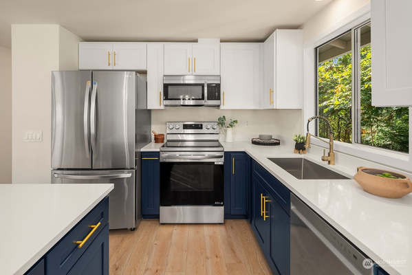 Kitchen Remodel, Bothell. - Two-tone kitchen designs are all the rage right now, and we’re loving how this one turned out! For this remodel, we used our bold blue shaker cabinets for the base and paired them with classic white upper cabinets for a fresh, balanced look. The gold accents add the perfect touch to tie everything together.