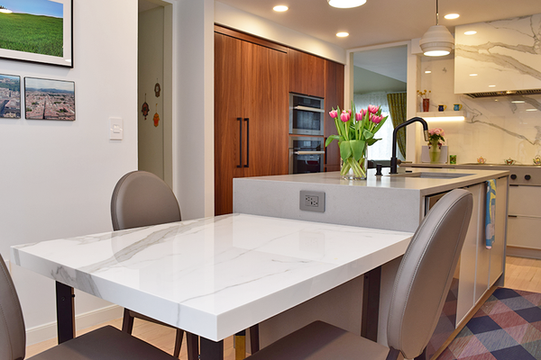 Quartz and Porcelain Kitchen - Raw Concrete Quartz countertops + island and Estatuario E05 Neolith Porcelain table top + backsplash + stove. Quartz and Porcelain Kitchen - Raw Concrete Quartz countertops + island and Estatuario E05 Neolith Porcelain table top + backsplash + stove.