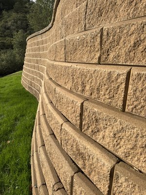 Allan Block retaining wall. - This retaining wall was created to build a big patio on a hill