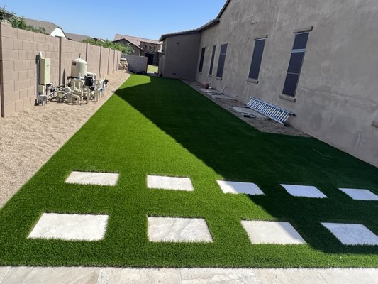 Turf & Travertine Steps - Base of minus (100 tons), Weed Chemical, Travertine Steps, 100 linear ft of Steel Border around the edge. 15 year manufacturer warranty turf 76oz face weight medium-high traffic with 2 pounds of silica sand per sqft.