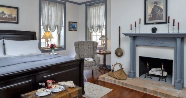 Thomas Jackson Room - This room is located on the main level at the front of the Inn, in the portion of the house dating to around 1804. This stately room was once a formal parlor, evidenced by a columned, brick fireplace. An impressive king sized sleigh bed is complemented by a couple of comfortable wing-back chairs perfect for reading or just relaxing. The raised 3-step en-suite bath features a large tiled shower.
This room includes two entries. There’s an inside entrance for convenience to the inn, plus a private outside entrance which leads to an intimate, secluded sitting area. The Jackson Room is named for the brilliant and eccentric General Thomas “Stonewall” Jackson, who having captured Harpers Ferry, enabled Lee to make a stand at Sharpsburg. Thomas Jackson Room - This room is located on the main level at the front of the Inn, in the portion of the house dating to around 1804. This stately room was once a formal parlor, evidenced by a columned, brick fireplace. An impressive king sized sleigh bed is complemented by a couple of comfortable wing-back chairs perfect for reading or just relaxing. The raised 3-step en-suite bath features a large tiled shower.
This room includes two entries. There’s an inside entrance for convenience to the inn, plus a private outside entrance which leads to an intimate, secluded sitting area. The Jackson Room is named for the brilliant and eccentric General Thomas “Stonewall” Jackson, who having captured Harpers Ferry, enabled Lee to make a stand at Sharpsburg.