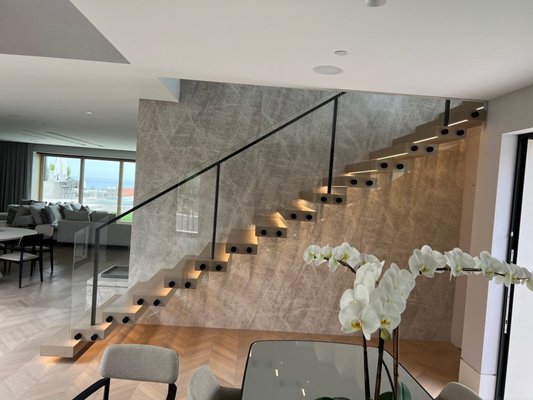 Glass Railings - Frameless glass railing featuring laminated low-iron glass with matte black standoffs, mounted on wood treads. Custom installed in Newport Beach for a clean, modern look. Glass Railings - Frameless glass railing featuring laminated low-iron glass with matte black standoffs, mounted on wood treads. Custom installed in Newport Beach for a clean, modern look.