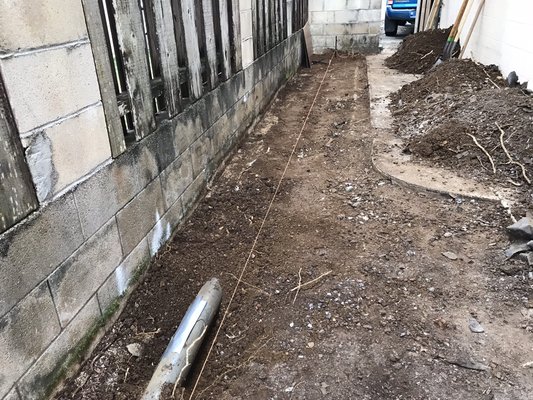 Kumoo Loop Project - This is an example of a sidewalk we poured for a customer. We installed drains to assist with the flow of water. Customer later contacted us to install Tan Vinyl Fencing on existing concrete block wall. Kumoo Loop Project - This is an example of a sidewalk we poured for a customer. We installed drains to assist with the flow of water. Customer later contacted us to install Tan Vinyl Fencing on existing concrete block wall.