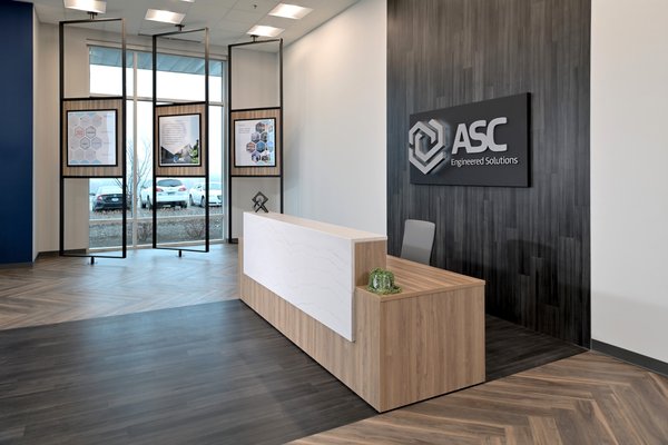 Corporate Hub - Intentional Spaces LLC was asked to create a design that provided a new home for teams brought together through a corporate merger. Not only was it important for the design to create a destination for the office space, but it was just as important to unify the teams under one roof. Artful displays pay homage to their individual histories while creating excitement for their combined future. Design elements throughout the facility uniquely feature products manufactured by the client to creatively divide zones within the large open areas and to create more intimate zones that bring teams together. A playful design focused on it's people and their experience within their new work home.