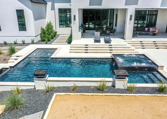 Hill Country Haven: Luxury Pool Design with Stunning Spa - This luxurious backyard retreat seamlessly blends elegance with functionality. The expansive custom pool features a stunning infinity edge that creates a visual flow into the natural landscape, enhancing the serene surroundings. The raised spa is adorned with shimmering mosaic tile, adding vibrant color and texture, while integrated fire bowls provide a dramatic touch for evening ambiance. The spacious patio area offers ample seating, ideal for entertaining or relaxing while enjoying the tranquil Texas Hill Country views. This project is the perfect balance of sophisticated design and resort-style comfort. Hill Country Haven: Luxury Pool Design with Stunning Spa - This luxurious backyard retreat seamlessly blends elegance with functionality. The expansive custom pool features a stunning infinity edge that creates a visual flow into the natural landscape, enhancing the serene surroundings. The raised spa is adorned with shimmering mosaic tile, adding vibrant color and texture, while integrated fire bowls provide a dramatic touch for evening ambiance. The spacious patio area offers ample seating, ideal for entertaining or relaxing while enjoying the tranquil Texas Hill Country views. This project is the perfect balance of sophisticated design and resort-style comfort.
