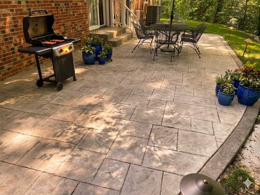 Stamped concrete patio Springfield - This customer had a sloped backyard that was associated, that he was fighting a long-term battle to grow a decent lawn. We met and discussedoptions to not only expand and replace the existing patio, but also to level out the grade so that the grandkids had some space to play! The landscape lighting added a warm touch for the evening, entertaining, and the new, wider steps and railing at the rear door created much safer access into the home. Stamped concrete patio Springfield - This customer had a sloped backyard that was associated, that he was fighting a long-term battle to grow a decent lawn. We met and discussedoptions to not only expand and replace the existing patio, but also to level out the grade so that the grandkids had some space to play! The landscape lighting added a warm touch for the evening, entertaining, and the new, wider steps and railing at the rear door created much safer access into the home.