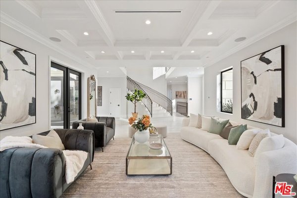 Estate Living - For this home, we went with a soft contemporary design direction with transitional touches to add contrast with the specifications of the home. The furniture selection consists of various wood tones, neutral linens, and marbles to add an overall arching feel of sophistication. The accessories highlight the furniture with a blend of neutral tones and sage green touches to add a sense of warmth. These colors tie in with the bold art pieces and softened with greenery that will speak to any future homeowner.