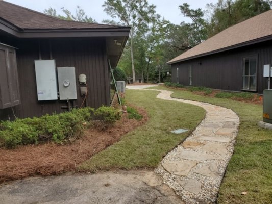 Retaining wall and paver sidewalk - This is a retaining wall project completed by our crew of professionals. We also completed for this customer a customized sidewalk. Call us today to get a free quote for your dream project.