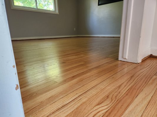 Red Oak Refinished in Natural - The client called us in for a floor restoration. Some oak boards were replaced. Our goal was to remove all traces of pet stains, deep gouges, and blemishes.
After our thorough sanding process, we achieved a stunning result: the natural beauty of the red oak was revealed, free from stains and imperfections. We didn't need to apply a stain colour, as the raw wood’s natural hue spoke for itself.
To complete the restoration, we sealed the wood with a primer and applied two coats of oil-based polyurethane with a satin sheen. The final finish adds durability while enhancing the natural warmth of the wood. Red Oak Refinished in Natural - The client called us in for a floor restoration. Some oak boards were replaced. Our goal was to remove all traces of pet stains, deep gouges, and blemishes.
After our thorough sanding process, we achieved a stunning result: the natural beauty of the red oak was revealed, free from stains and imperfections. We didn't need to apply a stain colour, as the raw wood’s natural hue spoke for itself.
To complete the restoration, we sealed the wood with a primer and applied two coats of oil-based polyurethane with a satin sheen. The final finish adds durability while enhancing the natural warmth of the wood.