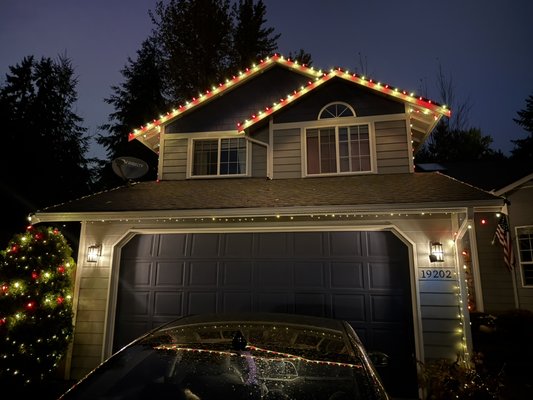 Beautiful holiday lighting setup on a two-story home! - This holiday lighting project was completed on a two-story family home in Bonney Lake, WA. The goal was to create a warm, festive, and elegant look while keeping the design clean and symmetrical.
We installed high-quality LED lights along the roofline, entryway, and garage, and decorated the outdoor tree with a mix of warm white and red bulbs to add character and depth.
The entire setup was planned and installed with precision and attention to detail — all cables are hidden, connections are weather-protected, and the overall design complements the home’s architecture.
The result is a cozy and festive atmosphere that the homeowners and neighbors absolutely love.