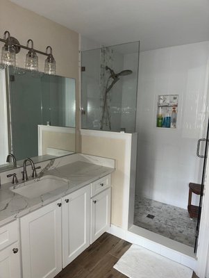 Bathroom Remodel - Complete remodel of this bathroom.  Replaced the vanity and countertop.  Installed new light fixtures.  Removed the bathtub and tiled the walls with a waterfall accent and niche.