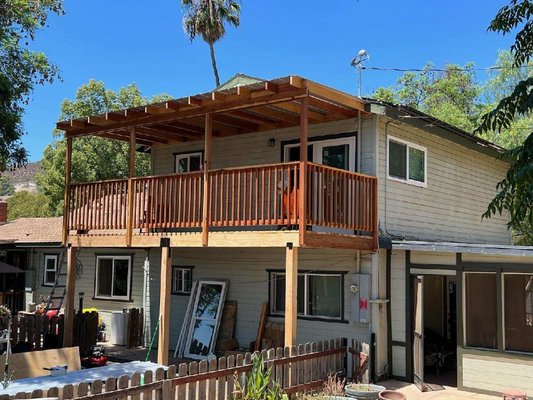 New Redwood Deck w/metal canopy. - Our client wanted a deck installed so that she would be able to sit outside. We built from the ground up a new Redwood Deck with a metal can