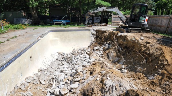 Concrete pool demolation - This pool was not being used by the homeowner any more. She wanted it demolished, removed and filled in to create a new garden.