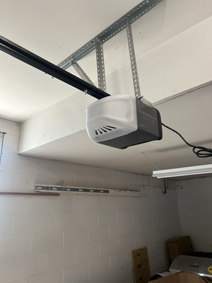 New garage door opener - In this project, we replaced an old, noisy Chamberlain chain-drive opener with a modern, quiet belt-drive model. The outdated opener had served its time but lacked the efficiency and convenience of today’s technology. The new belt-drive system offers smooth operation, reduced noise, and smart features for remote access via a smartphone app. After safely removing the old unit, we installed and calibrated the new opener, ensuring seamless performance and testing all safety features. The homeowner was delighted with the transformation, enjoying a quieter, more reliable, and technologically advanced garage door system. New garage door opener - In this project, we replaced an old, noisy Chamberlain chain-drive opener with a modern, quiet belt-drive model. The outdated opener had served its time but lacked the efficiency and convenience of today’s technology. The new belt-drive system offers smooth operation, reduced noise, and smart features for remote access via a smartphone app. After safely removing the old unit, we installed and calibrated the new opener, ensuring seamless performance and testing all safety features. The homeowner was delighted with the transformation, enjoying a quieter, more reliable, and technologically advanced garage door system.