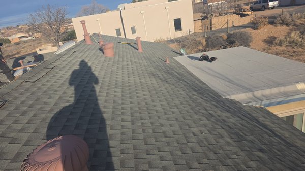 Stone Coated Metal Shingle in color Charcoal - In the Rio Rancho area, we have finished replacing the entire roof by tearing off the current shingles to the decking. In order to provide the new installation with a waterproof and long-lasting roof system, we first inspected the decking before installing in an ice and water shield barrier and underlayment. Then, in order to prevent wood rot, mold development, and mildew in the attic, we installed ridge vent. We finished this new roof replacement with a stone-coated metal shingle in the style “pacific tile" in the color "charcoal" . This new roof has a 50 year limited warranty .