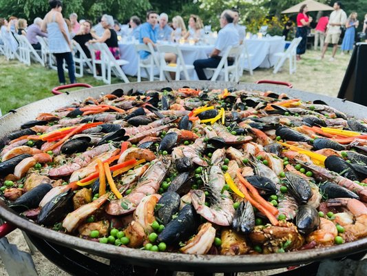Engagement Party August 2022 - We catered a beautiful outdoor engagement party for a couple in Redding, CT. Everything was held outdoors, and the guests dined on 2 different paellas - Land & Sea Paella and Vegan Paella served with a side of Mediterranean Tomato Salad with a shallot vinegar dressing. We provided 3 different starters - mini chicken empanadas, cheese chia taquenos, and an artisanal cheese and charcuterie board. There was a total of 60 guests at the party. Chef Alberto and his team were on site the entire time cooking the paella and serving all the guests. It was a memorable and interactive experience! Engagement Party August 2022 - We catered a beautiful outdoor engagement party for a couple in Redding, CT. Everything was held outdoors, and the guests dined on 2 different paellas - Land & Sea Paella and Vegan Paella served with a side of Mediterranean Tomato Salad with a shallot vinegar dressing. We provided 3 different starters - mini chicken empanadas, cheese chia taquenos, and an artisanal cheese and charcuterie board. There was a total of 60 guests at the party. Chef Alberto and his team were on site the entire time cooking the paella and serving all the guests. It was a memorable and interactive experience!
