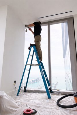 Motorized shade installation - Motorized shades enhance privacy, optimize natural light, and improve insulation, helping to reduce energy costs while elevating the overall aesthetic and functionality of any room. Ideal for hard-to-reach windows or contemporary living environments, this solution delivers both comfort and sophistication with minimal effort.