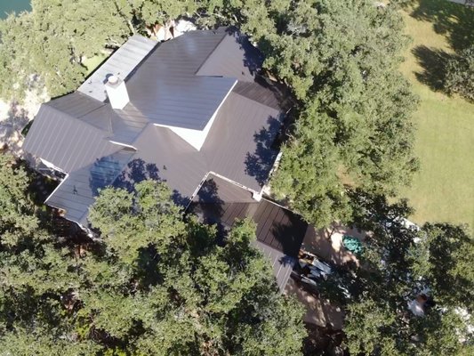 Shingle to Black Standing Seam Metal Roof — Before & After - Barnes N' Roofs replaced this home's asphalt shingle roof with black standing seam metal roofing. The 32-photo gallery follows the existing shingles, roof preparation, underlayment and metal panel installation through to the completed roof. Aerial and close-up photographs show the dormers, chimney and transitions between roof slopes. Explore the before-and-after views to compare this home's original roof with the finished metal roofing system. Shingle to Black Standing Seam Metal Roof — Before & After - Barnes N' Roofs replaced this home's asphalt shingle roof with black standing seam metal roofing. The 32-photo gallery follows the existing shingles, roof preparation, underlayment and metal panel installation through to the completed roof. Aerial and close-up photographs show the dormers, chimney and transitions between roof slopes. Explore the before-and-after views to compare this home's original roof with the finished metal roofing system.