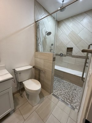Accessible Bathroom 2023 - "Transformed our bathroom into an accessible oasis! Removed a wall for a spacious shower with grab bars, a hand shower, ceiling rain shower, and niche. Installed lowered valves, a big shower seat, and a towel bar for convenience. Upgraded with a new vanity, sink, mirror, toilet, and fixtures. Enjoying luxury and functionality every day!" Accessible Bathroom 2023 - "Transformed our bathroom into an accessible oasis! Removed a wall for a spacious shower with grab bars, a hand shower, ceiling rain shower, and niche. Installed lowered valves, a big shower seat, and a towel bar for convenience. Upgraded with a new vanity, sink, mirror, toilet, and fixtures. Enjoying luxury and functionality every day!"