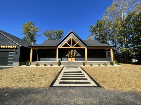 Asphalt Driveway, Concrete Sidewalk, Yard grading, Seeding & Garden installation. - Here are the final results of this beautiful new home! With our installations of an Asphalt Driveway, Stamp concrete walkway, garden installation, and yard completion.