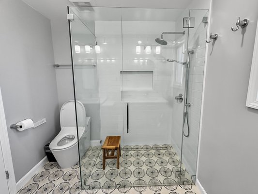 BATHROOM REMODEL - Manhaden Foster City - A small bathroom remodel we completed with a stand up shower, clear glass shower sliding glass doors, and a beautiful double vanity with beautiful pattern flooring.
