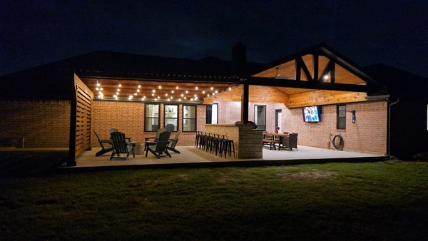 Patio and Privacy Trellis-Haslet - This client didn't have a patio at their house. They also wanted to create privacy from the neighbors. 
We installed a new concrete patio, a privacy trellis, and a new patio cover.