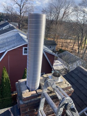 Little Falls, NJ Fireplace Liner Installation - First, we remove the existing terra cotta flue tiles. Next, we lined the fireplace flue, from the top of the smoke chamber to the top of the chimney, with a new, lifetime warranty, stainless steel chimney liner. Then, we restored all four walls of the smoke chamber using Chamber Tech 2000 refractory cement and poured Chim-Mix insulation around the entire chimney liner, from top to bottom. Finally, we installed a new, top mount, cable driven, damper-cap combo. Little Falls, NJ Fireplace Liner Installation - First, we remove the existing terra cotta flue tiles. Next, we lined the fireplace flue, from the top of the smoke chamber to the top of the chimney, with a new, lifetime warranty, stainless steel chimney liner. Then, we restored all four walls of the smoke chamber using Chamber Tech 2000 refractory cement and poured Chim-Mix insulation around the entire chimney liner, from top to bottom. Finally, we installed a new, top mount, cable driven, damper-cap combo.