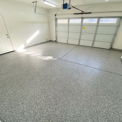 Ultimate Garage Floor Transformation - This project involved restoring a garage floor that was damaged in a home fire. We completely repaired the concrete floor spalling and then applied a durable and attractive flake epoxy floor system.