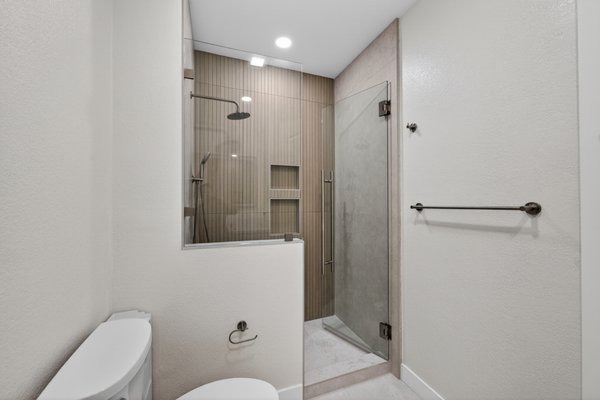 Upscale Bathroom with Glass Shower - modern bathroom, spa-inspired bathroom, walk-in glass shower, LED mirror, custom vanity, quartz countertop, contemporary bathroom design, luxury bathroom, frameless shower, neutral tones, elegant bathroom, modern fixtures, double vanity style, minimalist bathroom, high-end finishes, sleek cabinetry, bright bathroom, designer bathroom, upscale ensuite, modern interior design