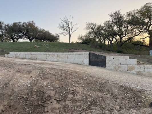 Retaining Wall Installation - Our customer wanted to drop the grade of their driveway to create better access to their home. As a result we needed to install a retaining wall to hold up the grade cut.