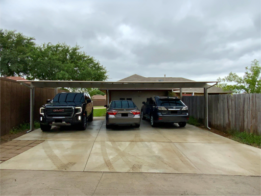 Driveway + Triple Carport Upgrade (Flower Mound, TX) - This Flower Mound home received a complete driveway replacement paired with a triple aluminum carport spanning the full width of the garage and driveway (approximately 26’ × 30’). The old driveway was cracked, uneven, and showing years of wear, so we removed the failing concrete and poured a new broom-finish driveway on a properly compacted base for long-term durability.

To complement the new driveway, the triple LJF Series aluminum carport was installed, providing full coverage, enhanced curb appeal, and lasting protection for vehicles. The combination of the upgraded driveway and carport gives the home a clean, functional, and polished look, improving both usability and overall aesthetics. Another smart, lasting upgrade by Patio Doctor.